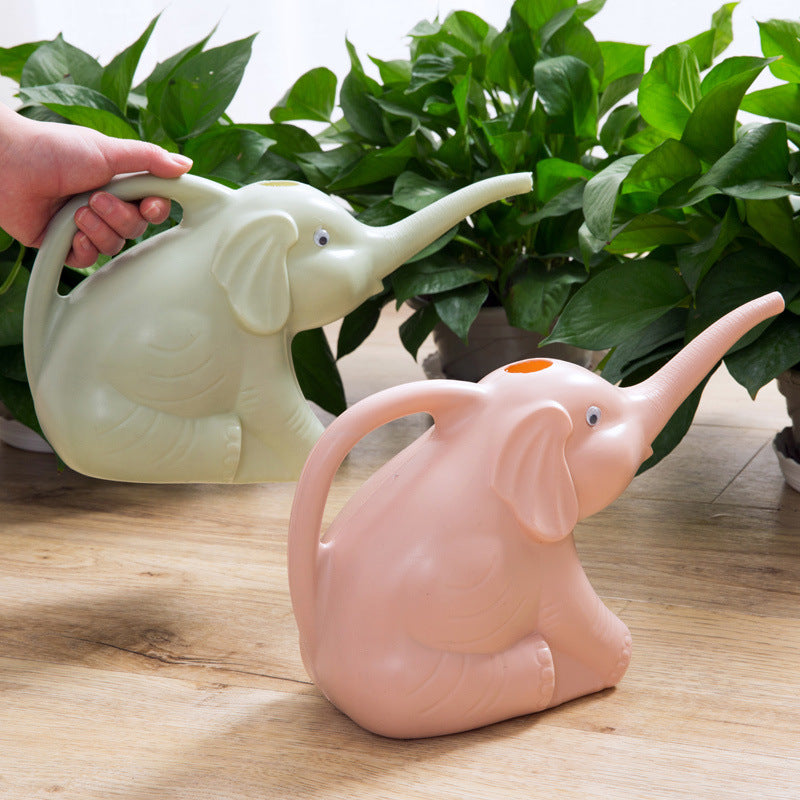 Baby elephant watering flowers